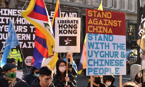 Protesters for democratic rights in China hold placards at a rally in London in December 2022.
