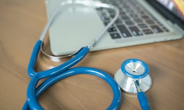 Stock image of a doctor's desk with stethoscope and laptop
