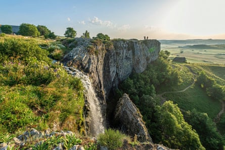 A rocky promontory with cascading waterfall