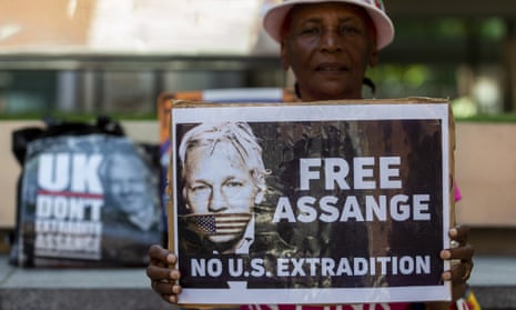 A supporter of Julian Assange holds up a sign outside the Home Office in London. Canberra has been urged to intervene in the Australian WikiLeaks co-founder’s extradition to the US.