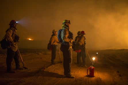 Firefighters tackle a major blaze near Ojai, California, in 2017. A class action lawsuit is being brought on behalf of female firefighters in the state.