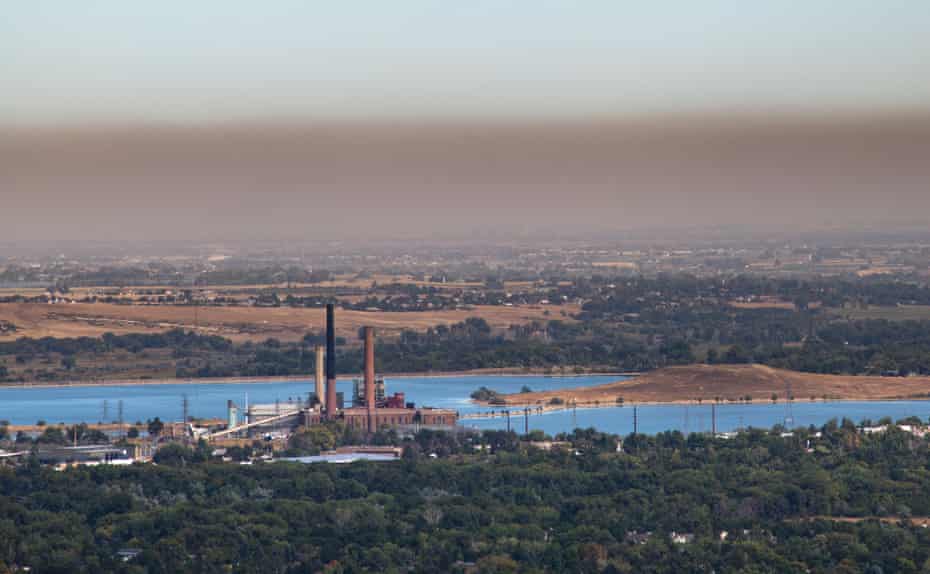 A brown cloud of pollution, caused in part by the nearby oil and gas operations, stretches along the Rocky Mountain Front.