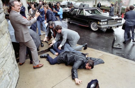 A White House aide and a police officer lie wounded outside the Washington Hilton after the assassination attempt on Ronald Reagan in March 1981.