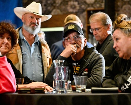 A dejected-looking group sitting around a table