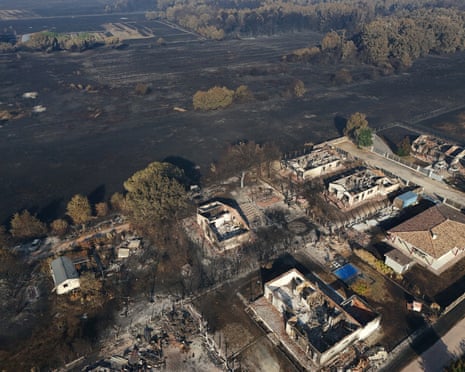 A drone view shows burnt buildings in an area affected by a wildfire in Le Porge, Gironde, France.