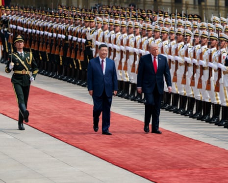Donald Trump inspects an honour guard during a welcome ceremony with Xi Jinping outsidse the Great Hall of the People in Beijing