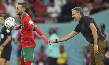 Hakim Ziyech shakes hands with Luis Enrique, head coach of Spain.