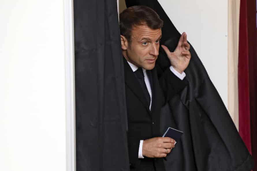 French president, Emmanuel Macron, exits a voting booth in Le Touquet, northern France