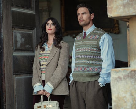 Woman and man stand outside doorway in sweaters