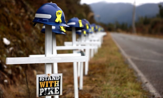 White crosses and saftey helmets are pictured on the access road to the Pike River Mine