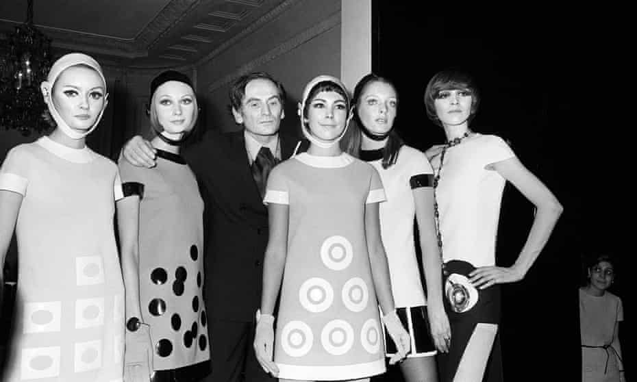 Pierre Cardin flanked by models after 1967 show in Paris. 