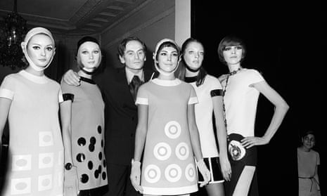 Pierre Cardin flanked by models after 1967 show in Paris. 