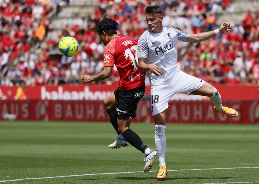 Real Mallorca’s Takefusa Kubo vies for the ball with Njegos Petrovic.