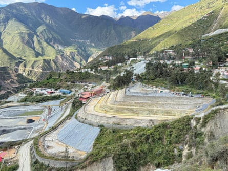 Terraced mine-workings in a valley among sunny mountains