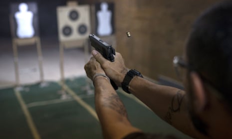 A pistol is fired during a practice session at the Calibre 12 gun club in Sao Goncalo, Brazil