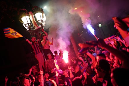 Barcelona fans celebrate in the street after their team won the title.