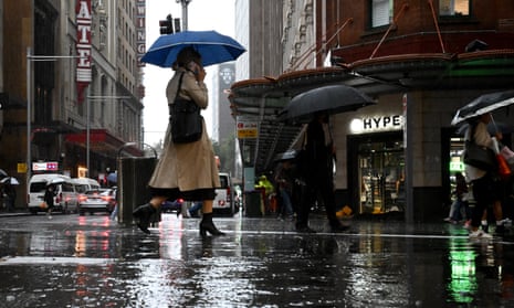 People walking through a wet city street