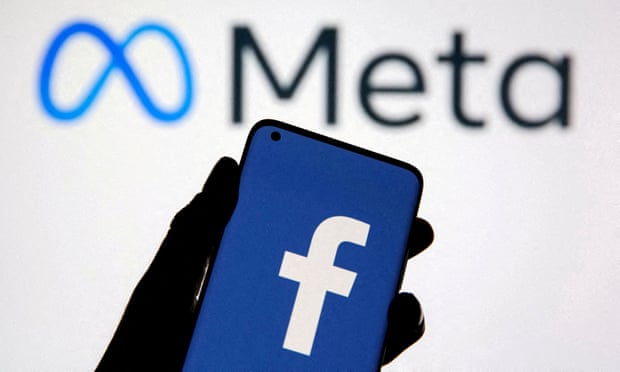 A smartphone with Facebook's logo is seen in front of displayed Facebook's new rebrand logo Meta in this illustration.