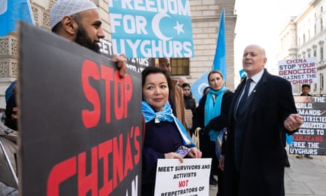 Iain Duncan Smith (right) joined a vigil outside the Foreign Office in London to protest at the planned visit to the UK of Erkin Tuniyaz, governor of the Chinese region of Xinjiang.