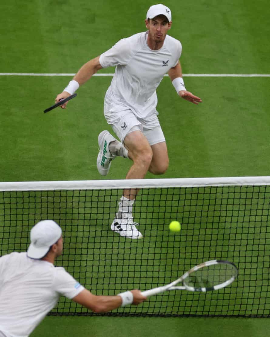 Andy Murray (top) and James Duckworth engage in some close net play.