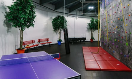 The top level features recreational options including table tennis and a rock climbing wall.