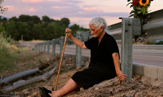 María Martín sits by the road which covers the mass grave containing her mother’s remains