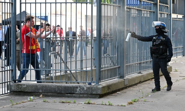 A French police officer applies some in-no-way-unnecessary crowd control techniques.