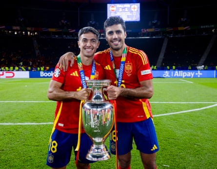Martín Zubimendi (left) poses with Rodri as they hold the Henri Delaunay Trophy after Spain’s Euro 2024 final victory over England