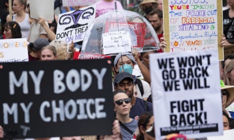 People gather in front of the Georgia state capitol in Atlanta on 24 June to protest against the supreme court's decision to overturn Roe v Wade.