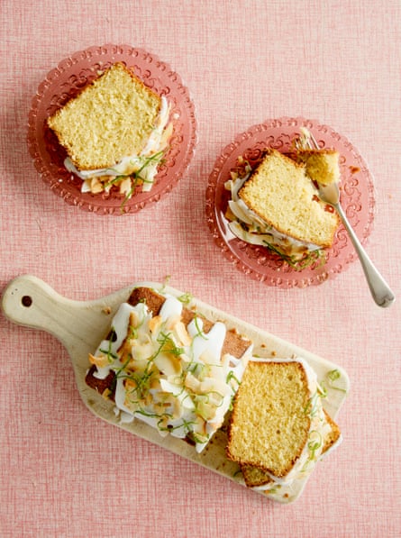 Thomasina Miers’ sticky pineapple and coconut loaf cake, on a very small chopping board – sliced – and with two plates burdened with fat slices of said cake. One of these slices has a fork through it, indicating that someone is about to eat it.
