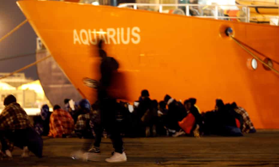 Migrants disembark from the Aquarius after its arrival in Sicily in January