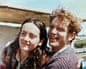 Kathering Scholes and Roger hugging one another near a fence under a blue sky in Launceston, Tasmania in 1982