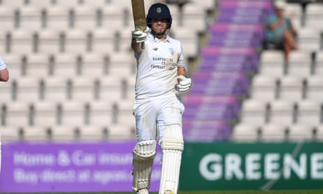 Liam Dawson raises his bat after scoring fifty.
