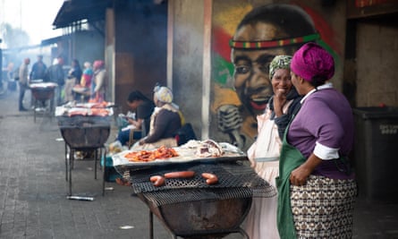 Women barbecue food in Nyanga township in Cape Town.