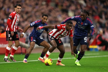Noah Sadiki of Sunderland surges away from the challenge of Arsenal’s Eberechi Eze.