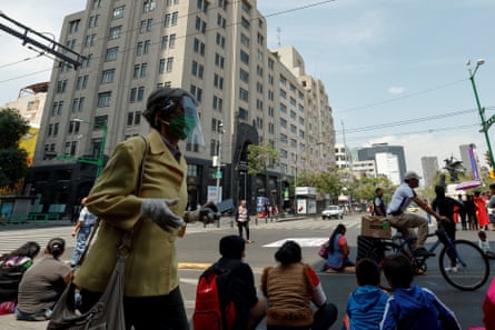 People wear masks as they walk the streets of Mexico City.