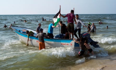 A small pleasure boat on a Gaza city beach takes bathers on a joy ride out to sea beyond the 200m limit contaminated by sewage.