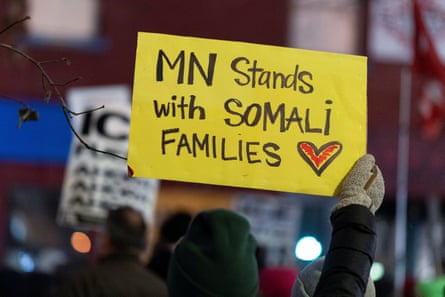 a hand holds a sign that reads ‘MN stands with Somali families’