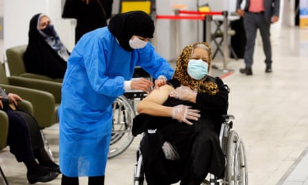 An elderly woman receives the Sinopharm COVID-19 vaccine at the Iran Mall shopping centre, in Tehran, in May 2021.