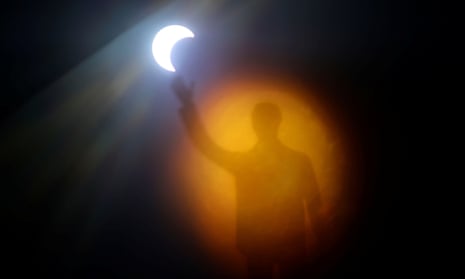 The moon crosses in front of the sun over the Juscelino Kubitschek memorial during an annular eclipse in Brasilia, Brazil in October 2023.