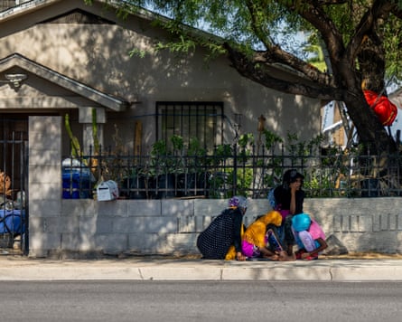 a family huddles under the shade of a tree