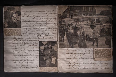 Newspaper clippings inside a handwritten journal