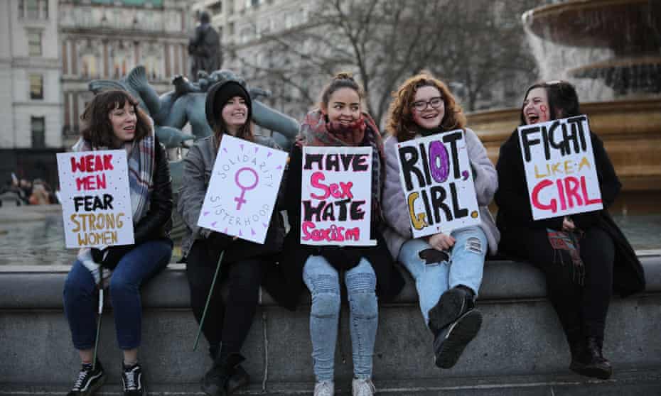Women’s March On London - group of women holding banners. One reads "fight like a girl".