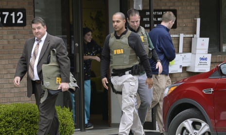 FBI agents leave the office of Dr Fakhruddin Attar at the Burhani clinic in Livonia, Michigan, on Friday after completing a search for documents.
