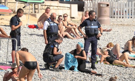 French police make woman remove clothing on Nice beach following burkini  ban, France