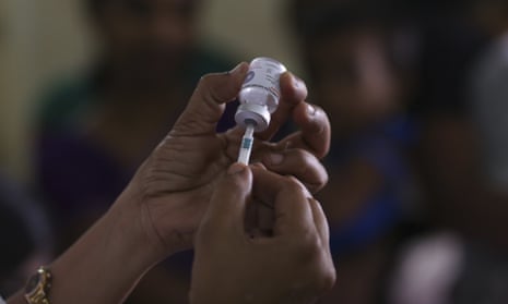 An Indian healthcare person prepares to administer an injection of inactivated poliovirus vaccine (IPV) to a child in Hyderabad, India