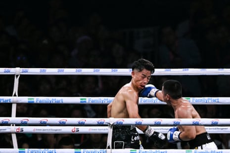 Yoshiki Takei (left) takes a punch during Saturday’s fight with DeKang Wang.
