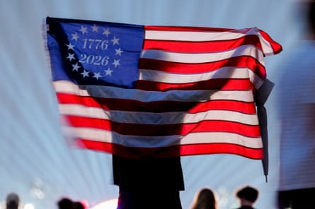 Silhouette of a person holding a US flag that says 1776/2026