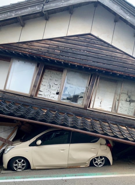 A car is trapped under a collapsed house in Shika town, Ishikawa.