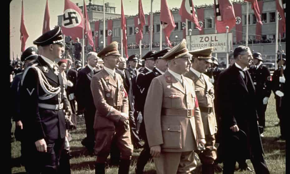 Neville Chamberlain (right) arrives at Oberwiesenfeld airport on the way to a meeting with Adolf Hitler, September 1938. 